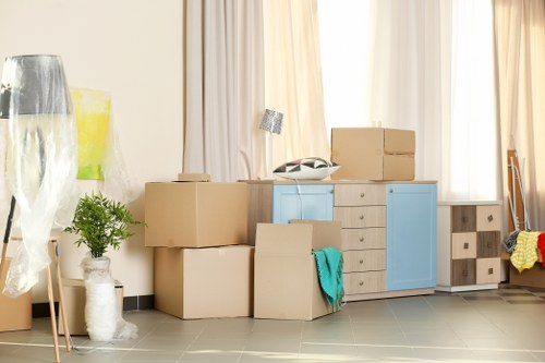 Professional movers assisting with a household move in Chertsey