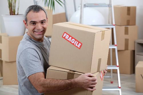 Professional movers assisting with household items in Byfleet