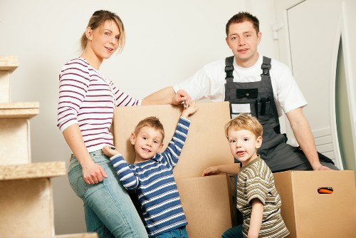 Professional movers handling large furniture in North Watford